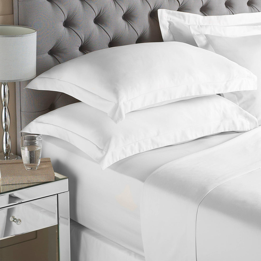 White fitted sheet folded and ready for the linen cupboard